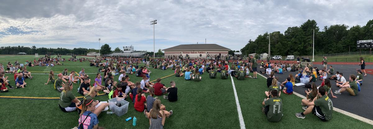D.A.R.E Kids Sitting on Football Field