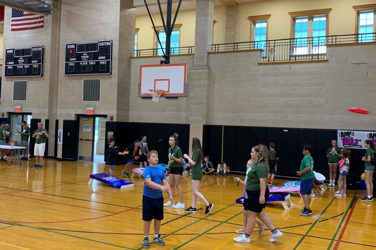 Kids playing games inside a school gym